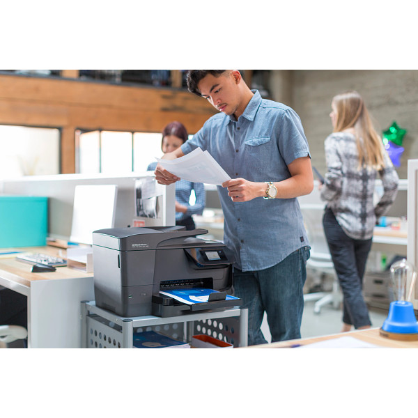 Man checking his prints from a HP Officejet Pro 8710 All-in-One Printer
