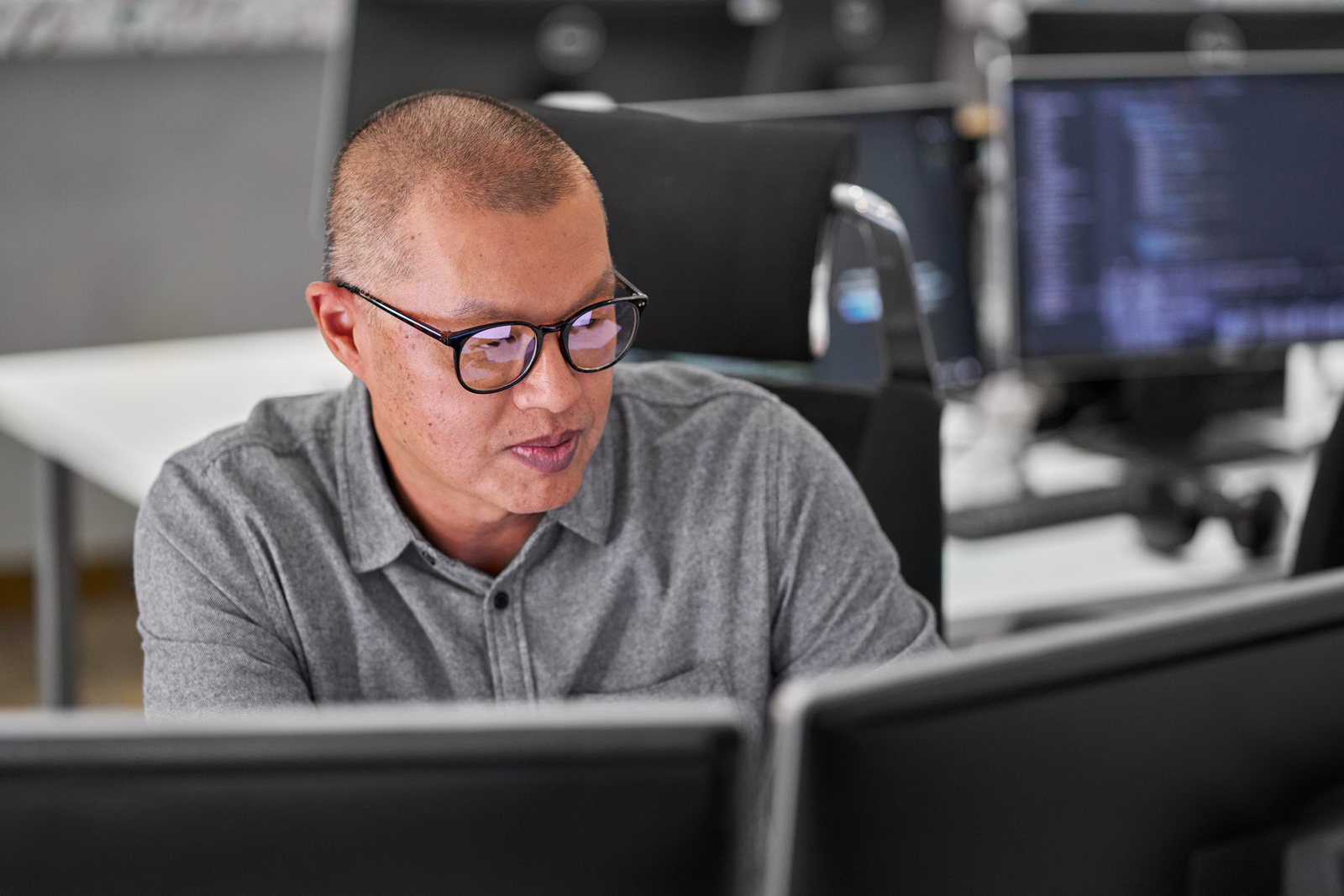 software engineer working behind two monitors